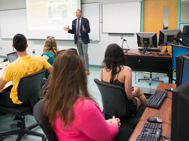Students in classroom being instructed by professor