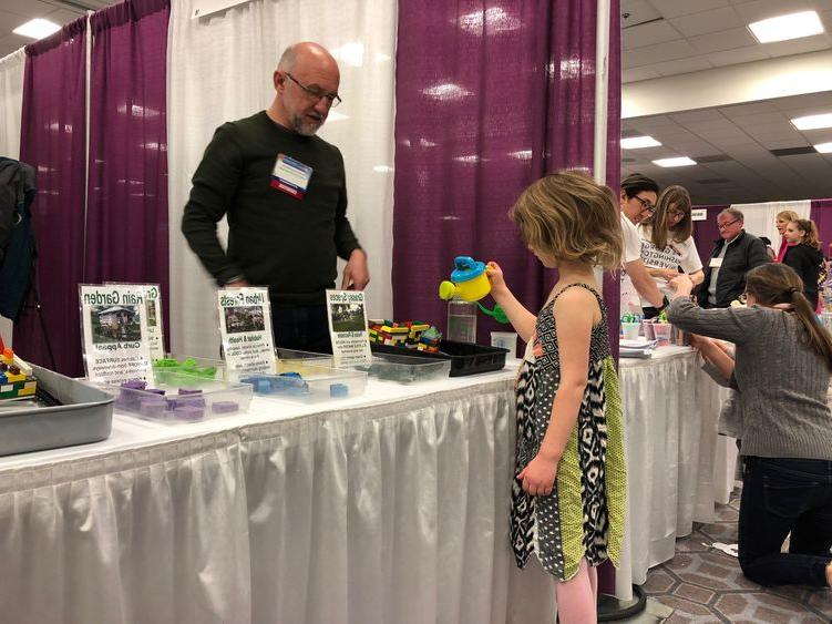 Mark Boudreau teaches a child about the environment. 