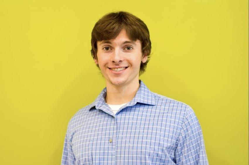 Man standing in front of bright yellow background